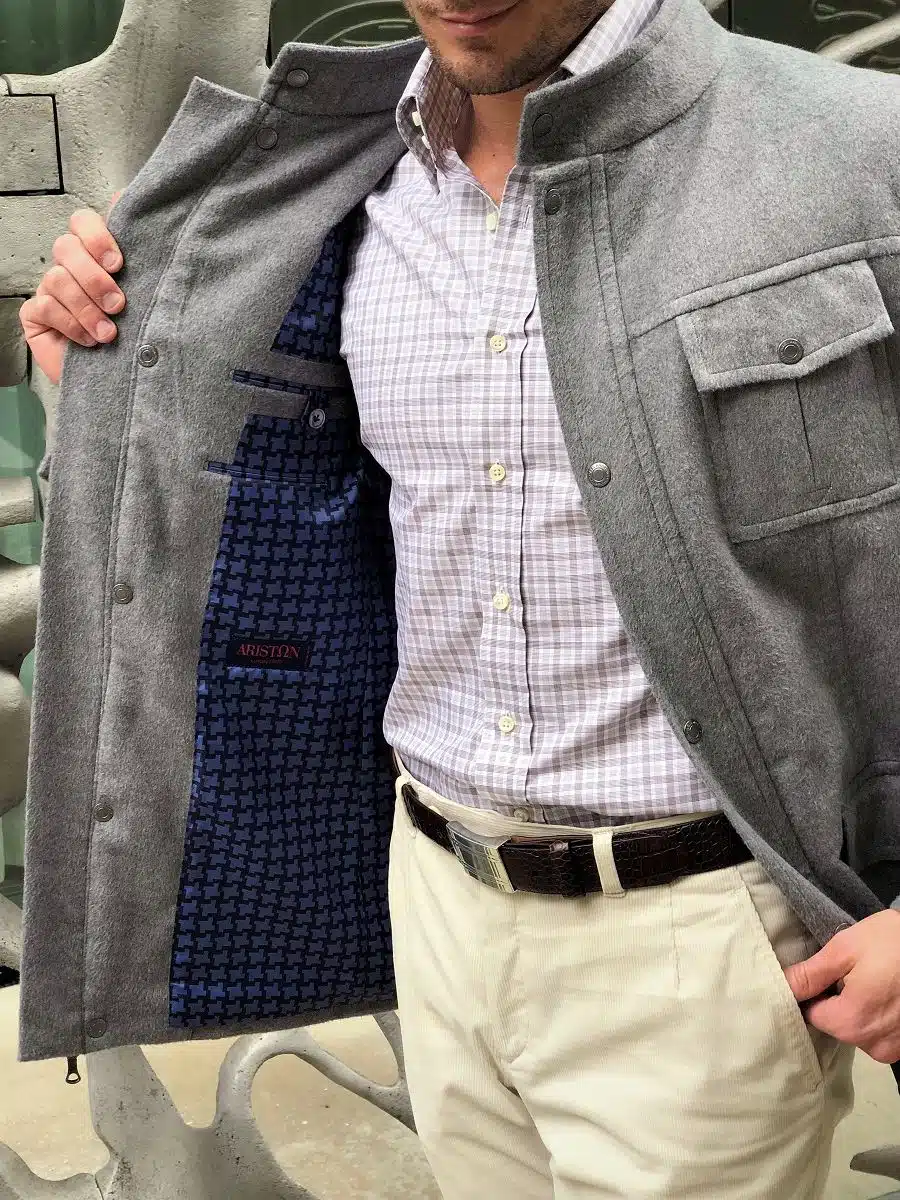 Open light grey field jacket revealing a blue plaid interior lining