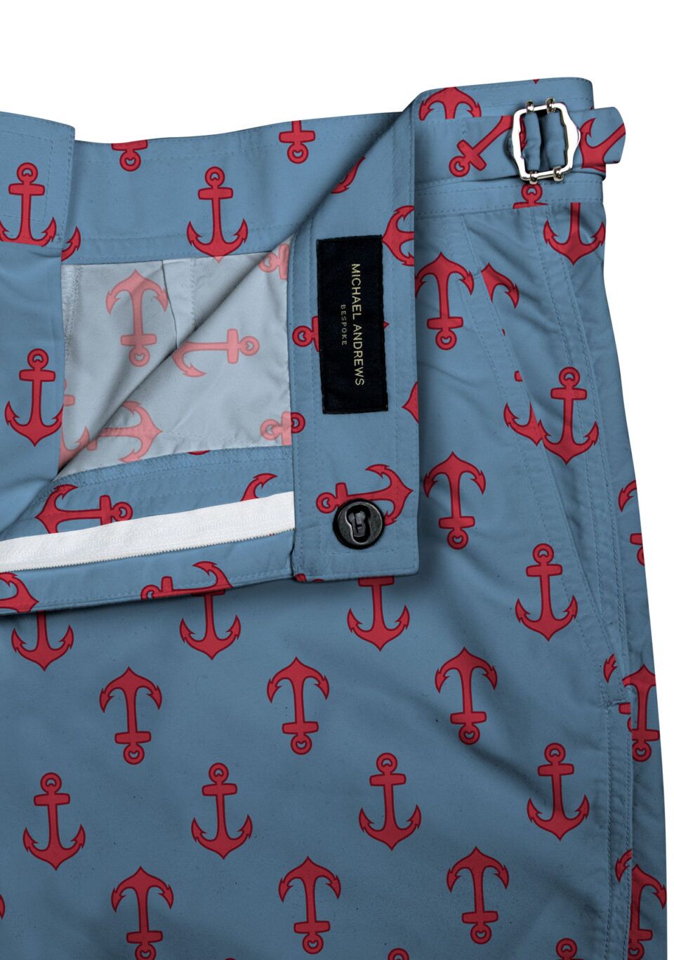 (product) Blue/Red Anchors Swim Shorts, close-up view showcasing lining and adjustable side tabs