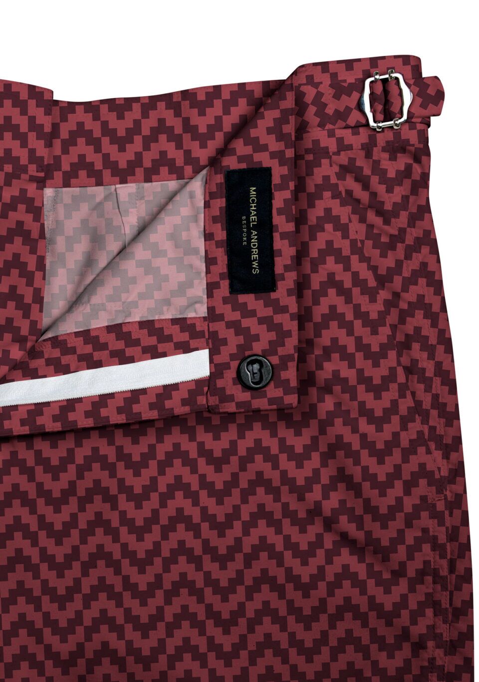 (product) Burgundy Zig-Zag Swim Shorts, close-up view showcasing lining and adjustable side tabs