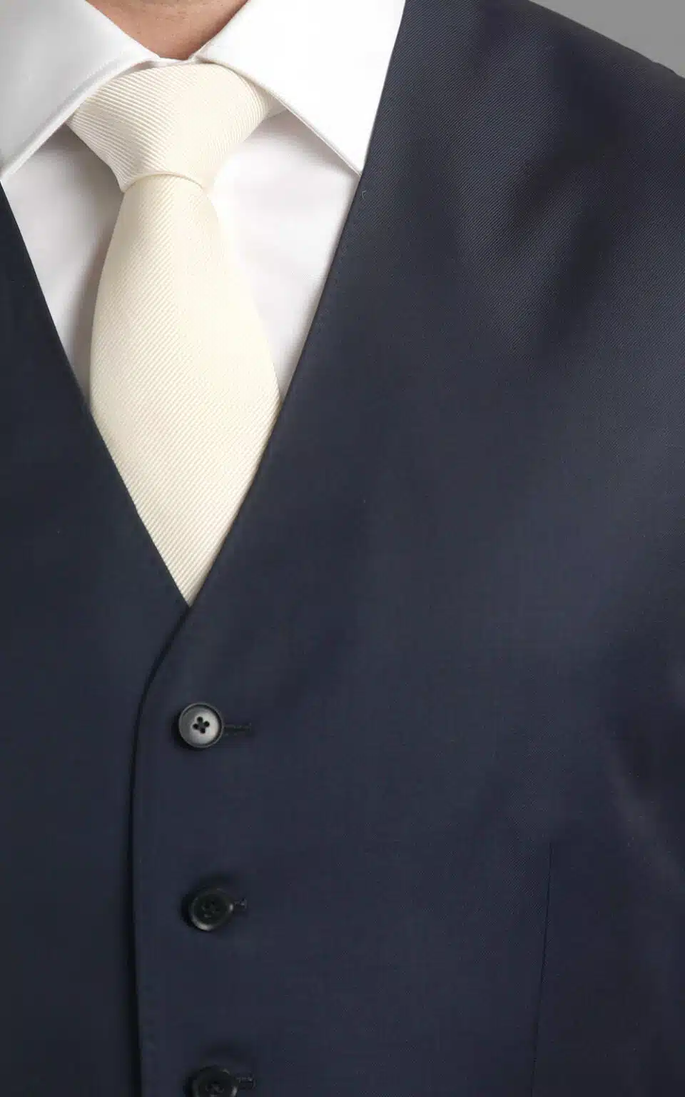(product) Navy Blue Twill MTM Suit, close-up of vest with a white neck tie