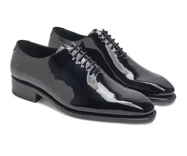 (product) Black Patent Leather Whole Cut Lace-Up, Side view of the pair